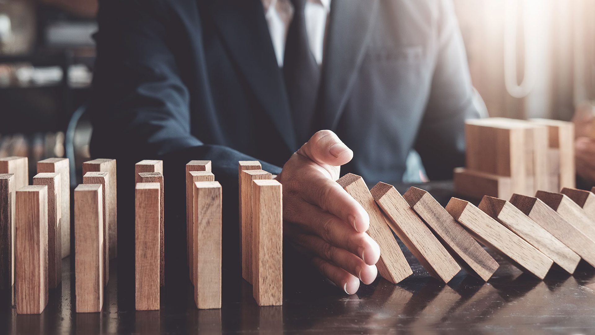 Business risk control concept, Businessman protect wooden block