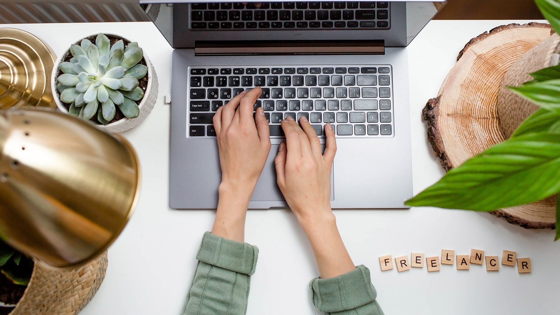 Workplace,At,Home.,Laptop,,Plants,And,Wooden,Lettering:,”freelance”,On